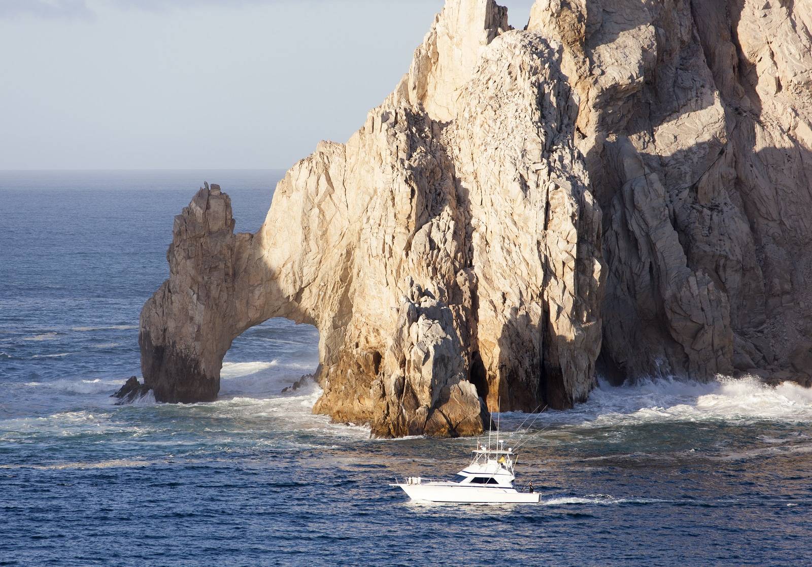 The boat passing by famous rock arch