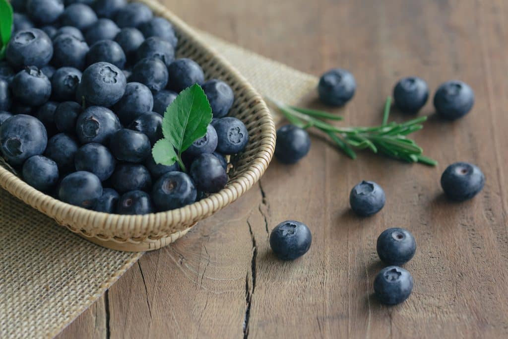 Fresh Wild Blueberries In Wood Basket On Sack. Wild Blueberry Pu