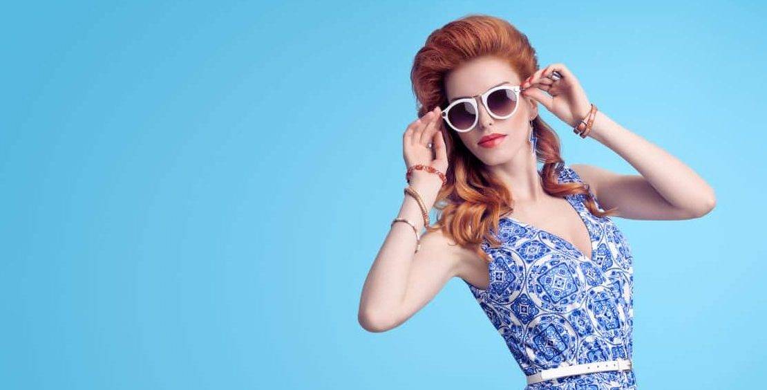Top 2018 fashion tips Redhead Model in Sexy Jumpsuit, woman in Trendy Summer Dress. Stylish wavy hairstyle, fashion Sunglasses, Summer Floral Outfit. Glamour fashion pose. Playful Beauty Girl, Luxury summer Lady