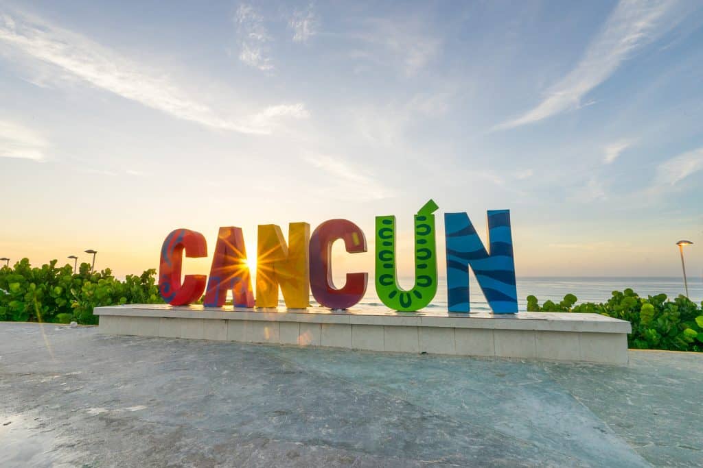 The Cancun sign at sunrise at Playa Delfines