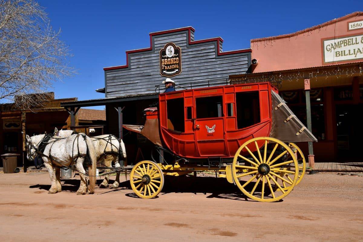 The white Percheron horses and red carriage is in Tombstone AZ