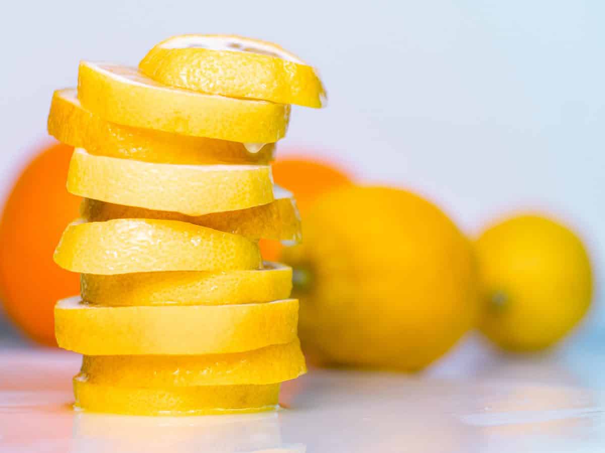 Set of two oranges two lemons and pile of lemon slices