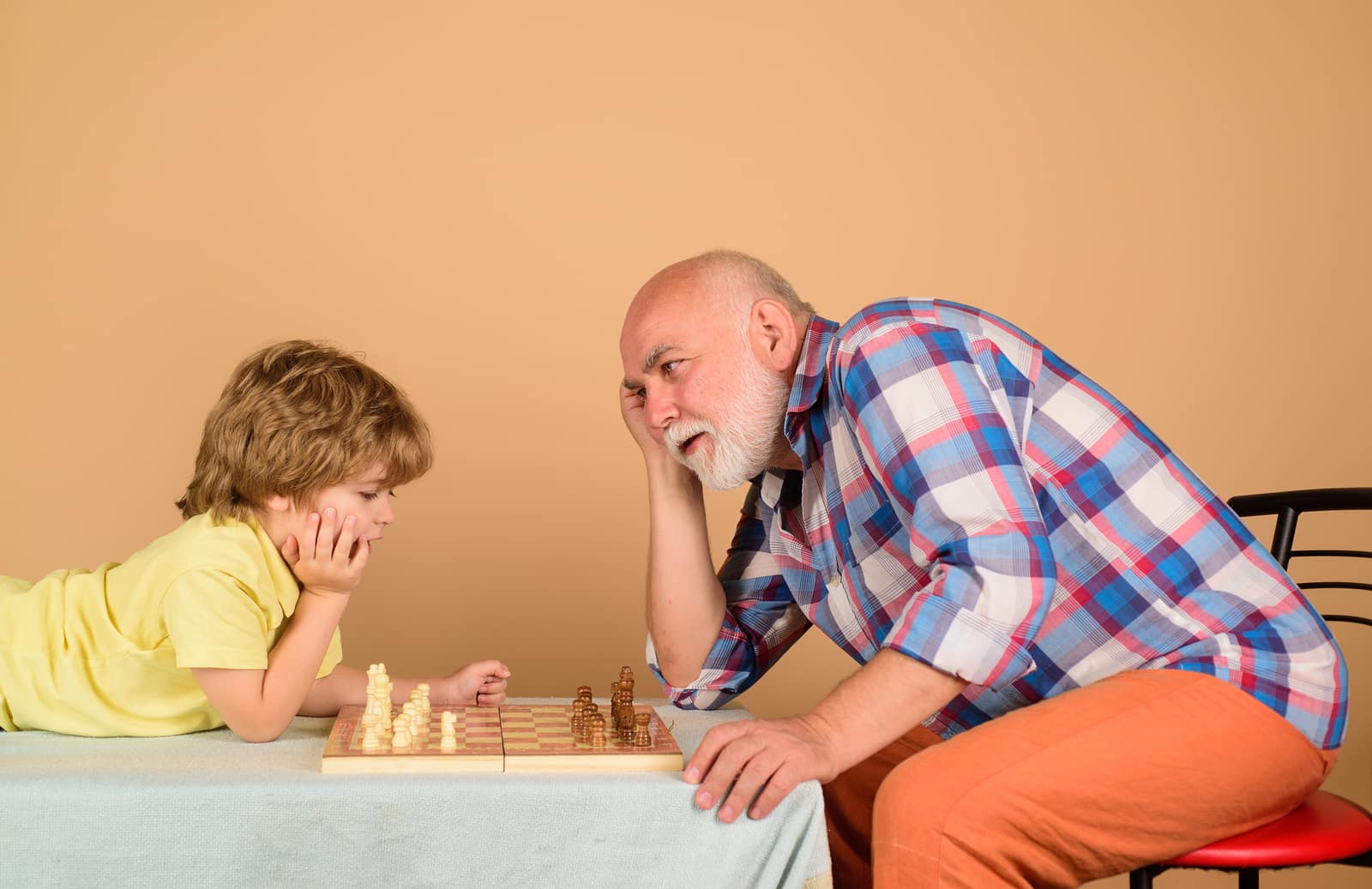 Grandfather and grandson playing chess