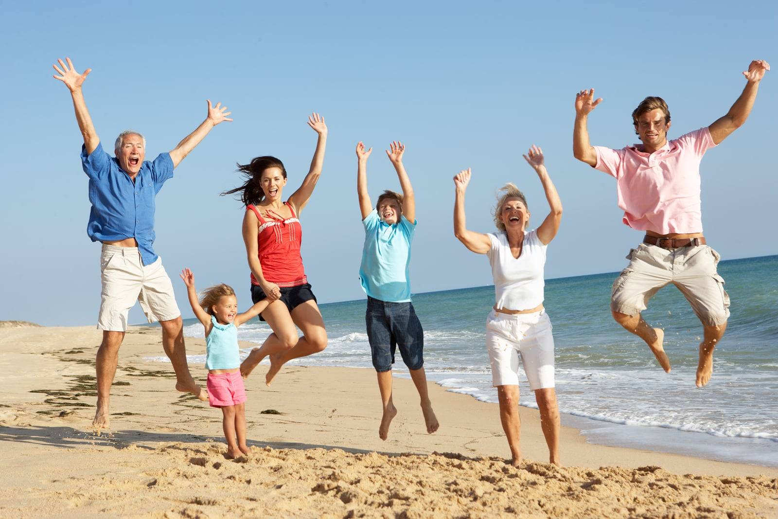 Three Generation Family On Beach Holiday Jumping In Air, 10 Must-Have Items for a Vacation
