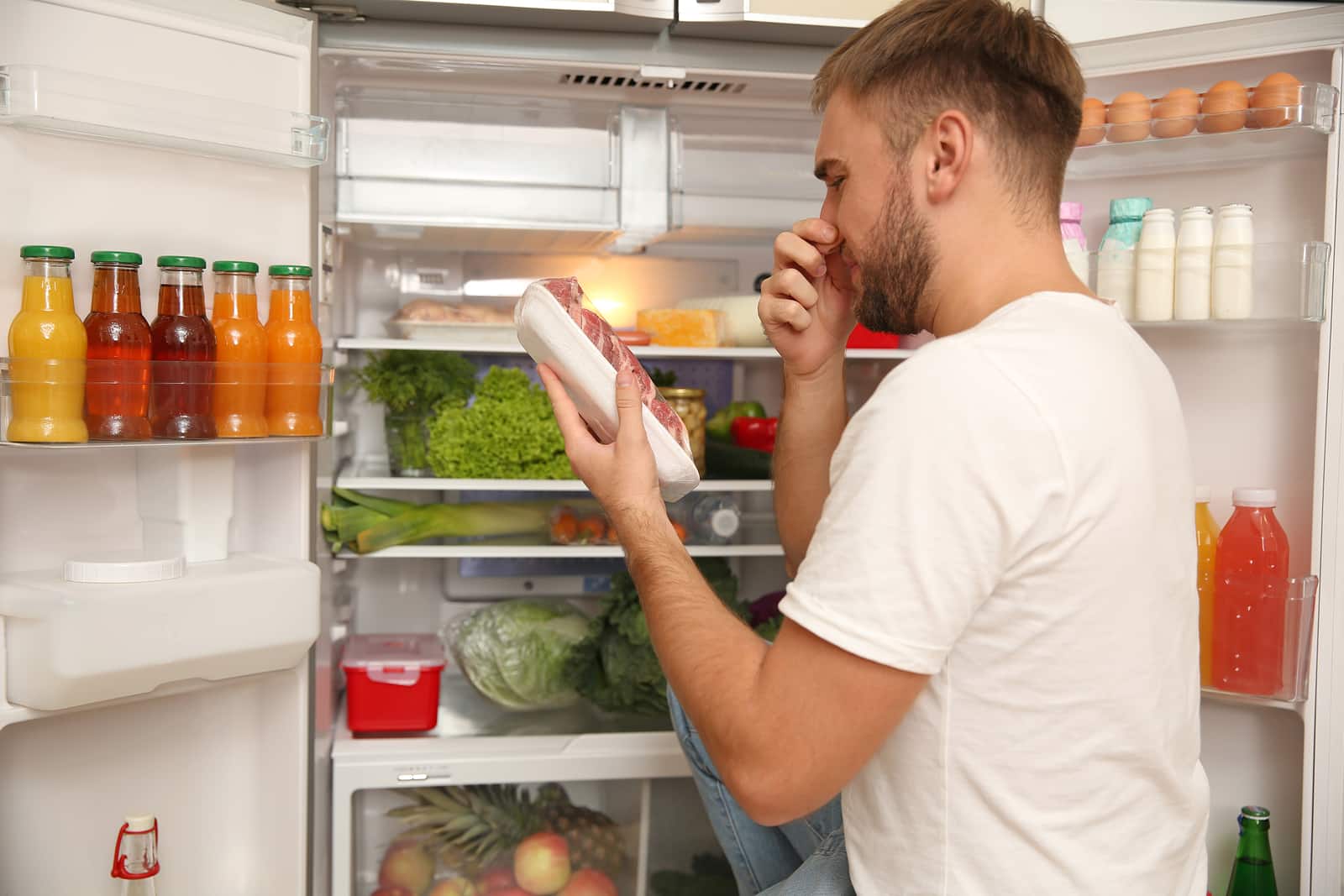 bad smelling meat near refrigerator in kitchen