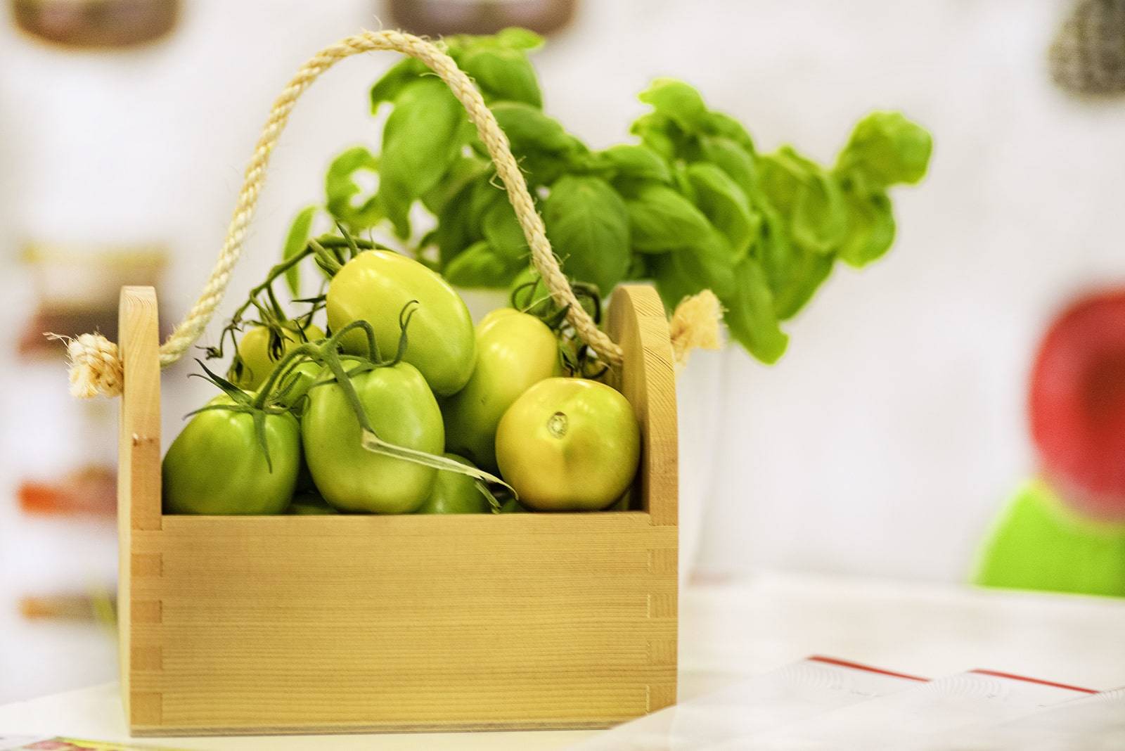 A close-up photo of a still-green tomato