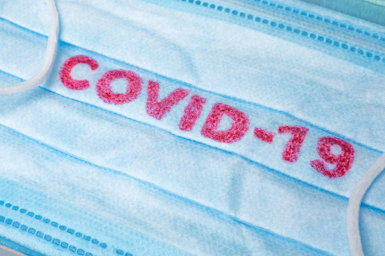 Disposable Face Mask with covid-19 printed on it.
