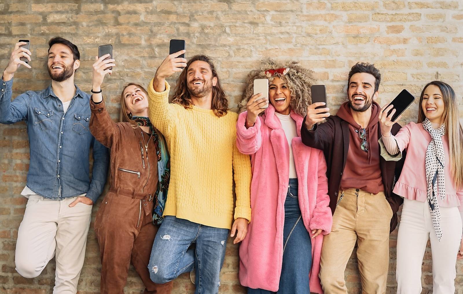Happy group friends taking selfie with cell phone outdoo