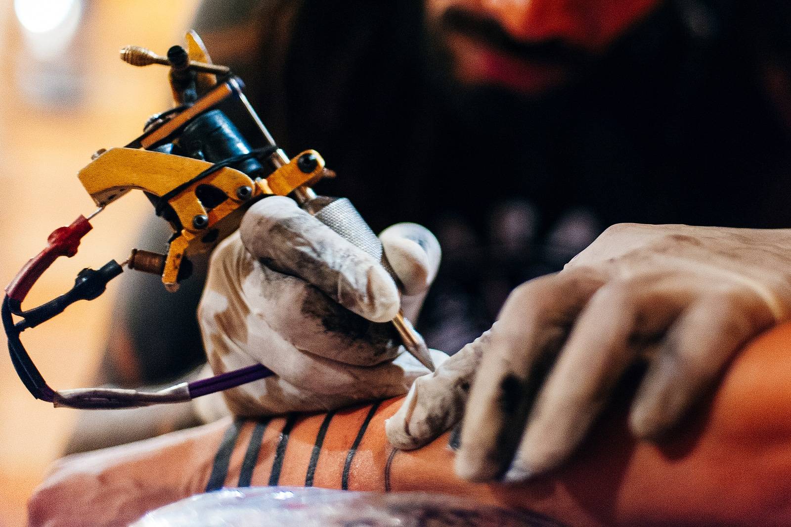 Tattoo Artist Doing Tattoo In Tatoo Salon On The Hand