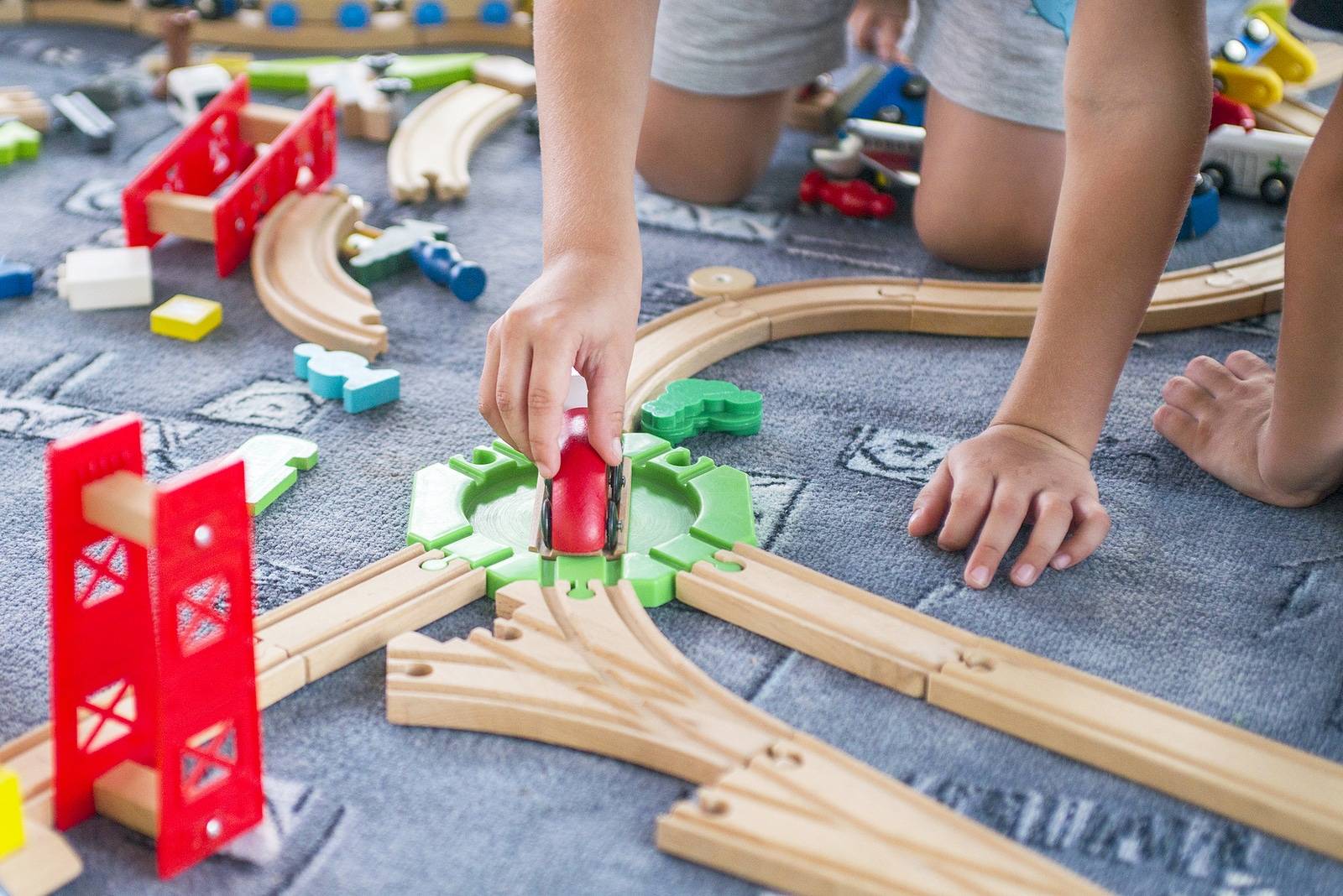 Children playing with wooden train