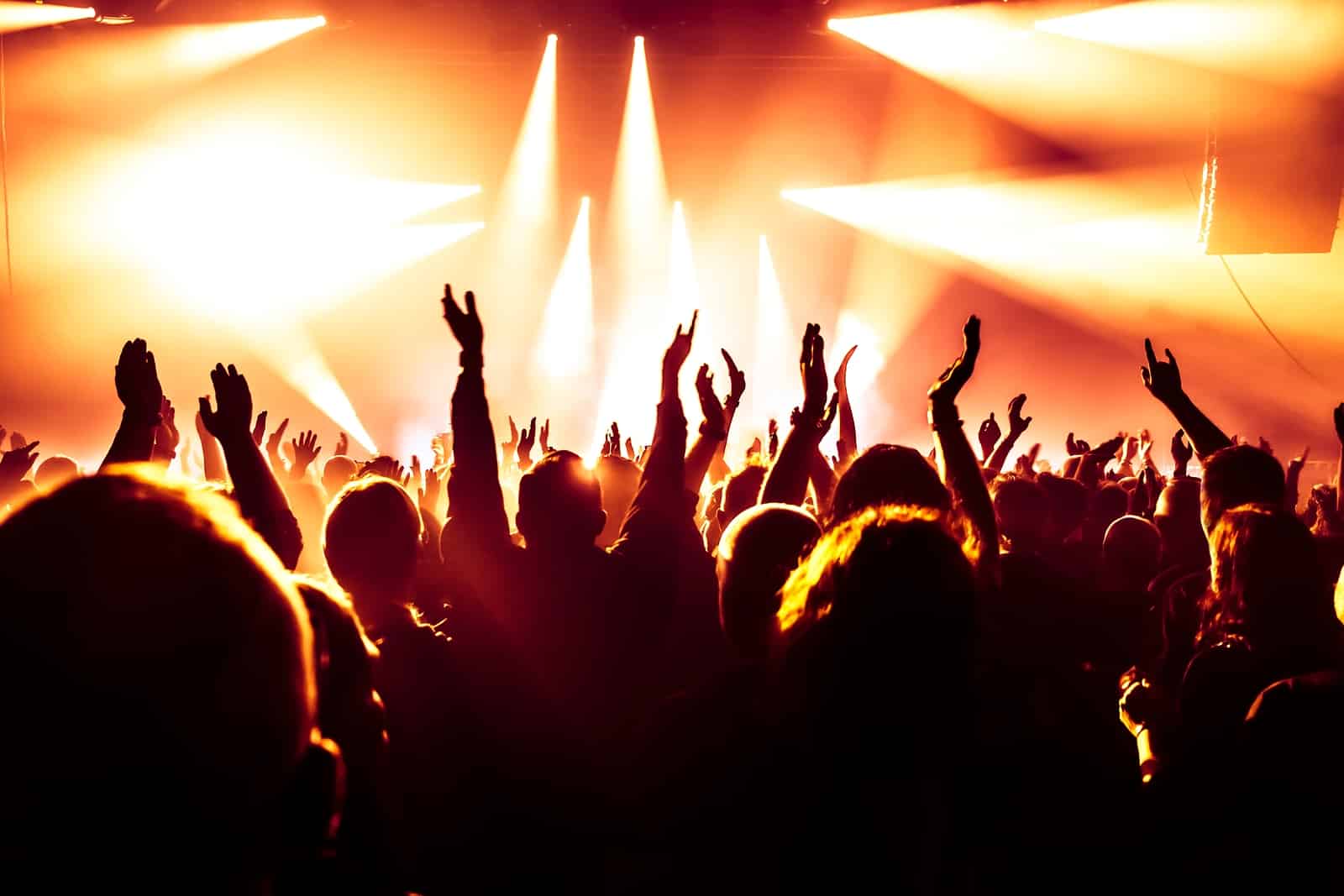 concert crowd at rock concert in front of bright stage lights