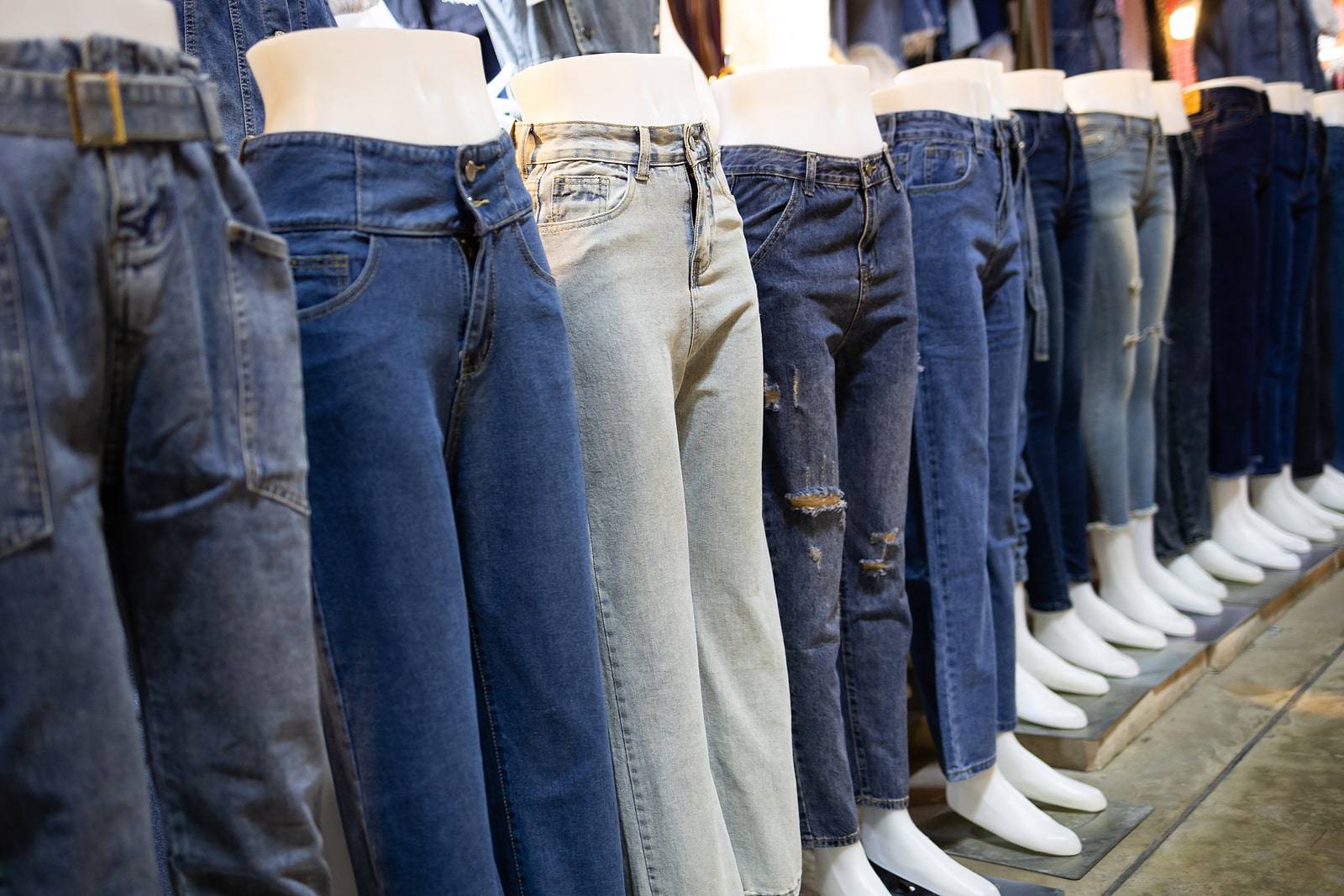 Collection of various types of blue jeans trousers