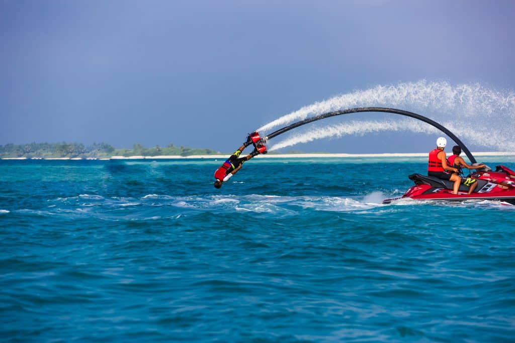 Silhouette Of A Fly Board Rider At Sea. Professional Rider Do Tr